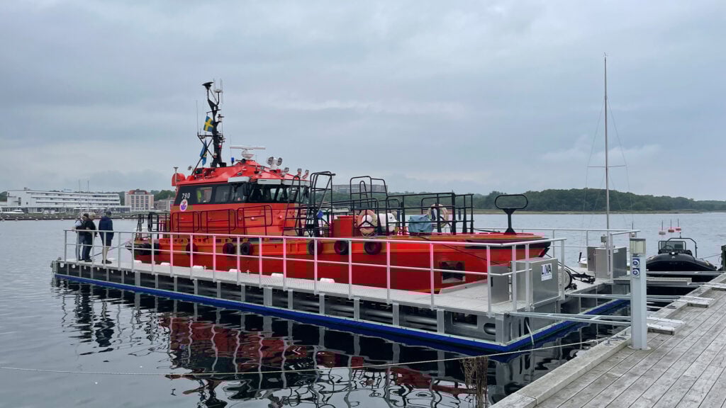 En orange räddningsbåt ligger förtöjd i en båttvätt.